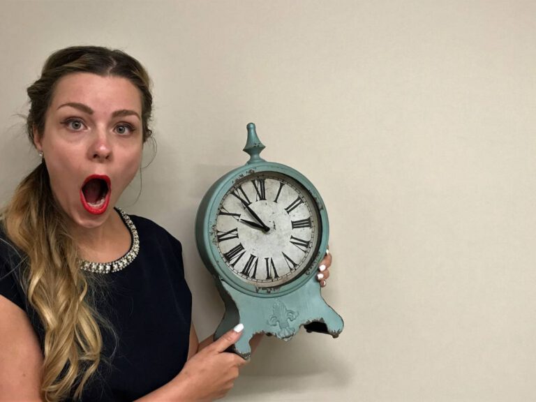 Dr. Cindy Nagel holding up a clock reminding you there's still time to visit Horizon Dental Kamloops