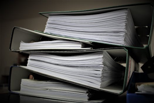 Close-up of stacked binders filled with documents for office or educational use.
