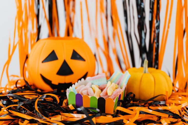 Vibrant Halloween display with a carved pumpkin, colorful candy, and festive decorations.
