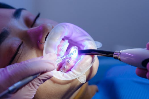Close-up of a dental procedure using LED light curing for orthodontic treatment